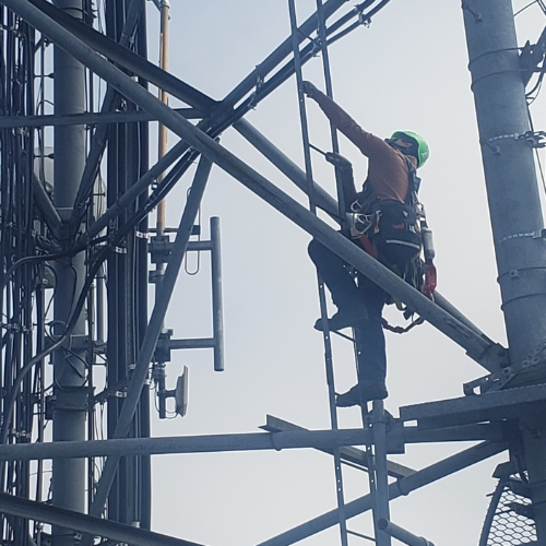 DESC Radio Communications staff member climbing tower