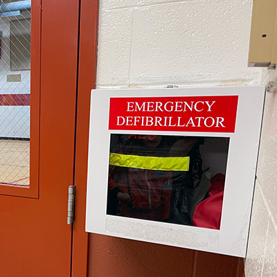 aed on wall outside school gymnasium