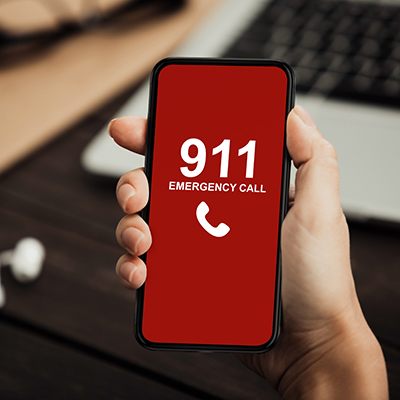 hand holding smartphone dialing 911
